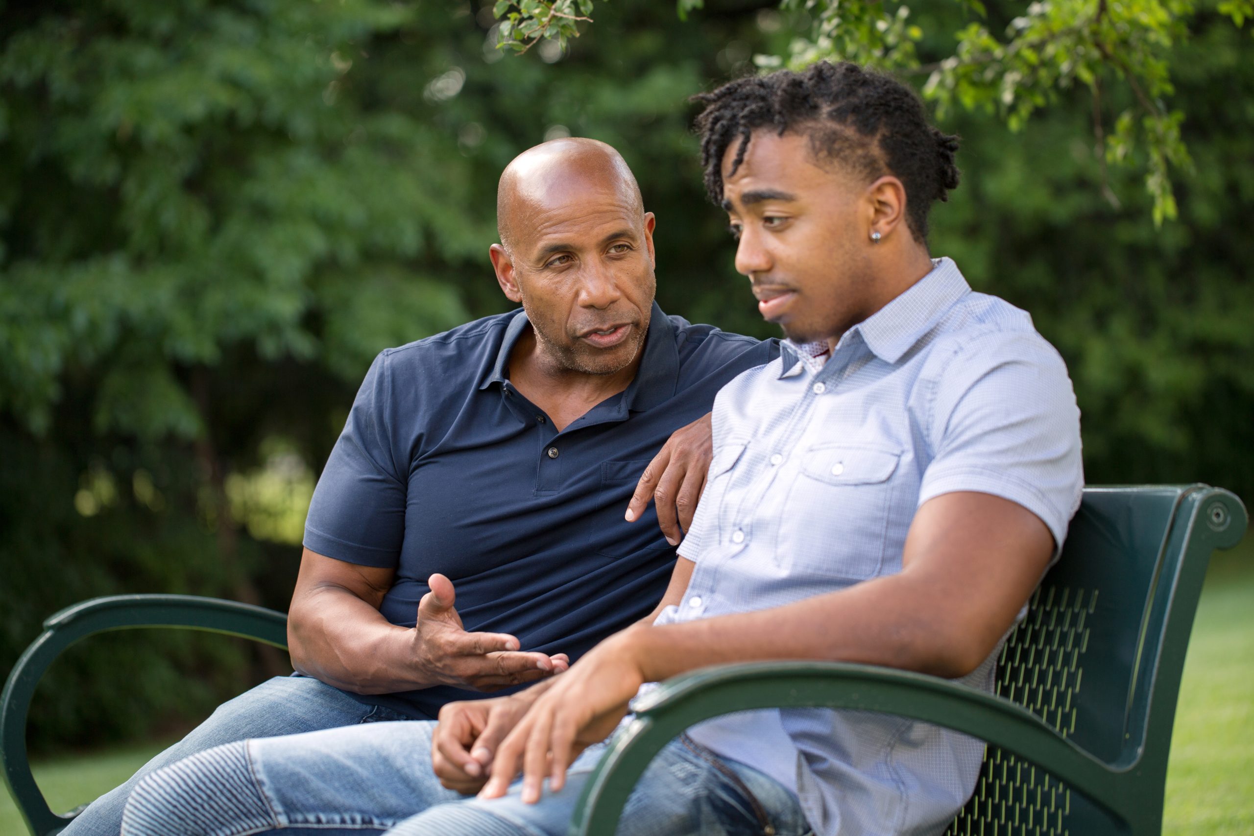 Mature man mentoring and giving advice to a younger man.